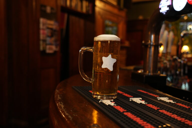 A pint of lager on the bar