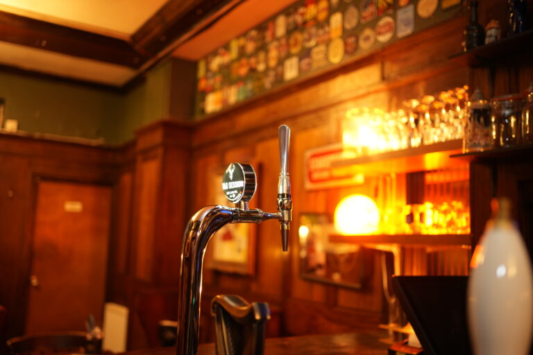 Brass beer tap at the wood-panelled bar